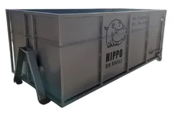 Bin rental Balzac service features a large metal dumpster with a cartoon hippo logo on wheels